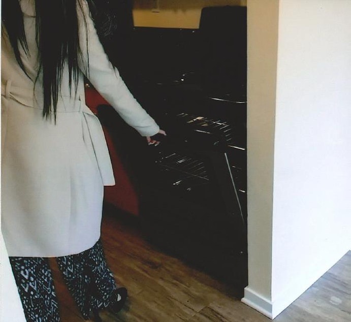 caption: Allied Residential property manager, Denise Farris, opens the stove during Natasha Weled's move out inspection.