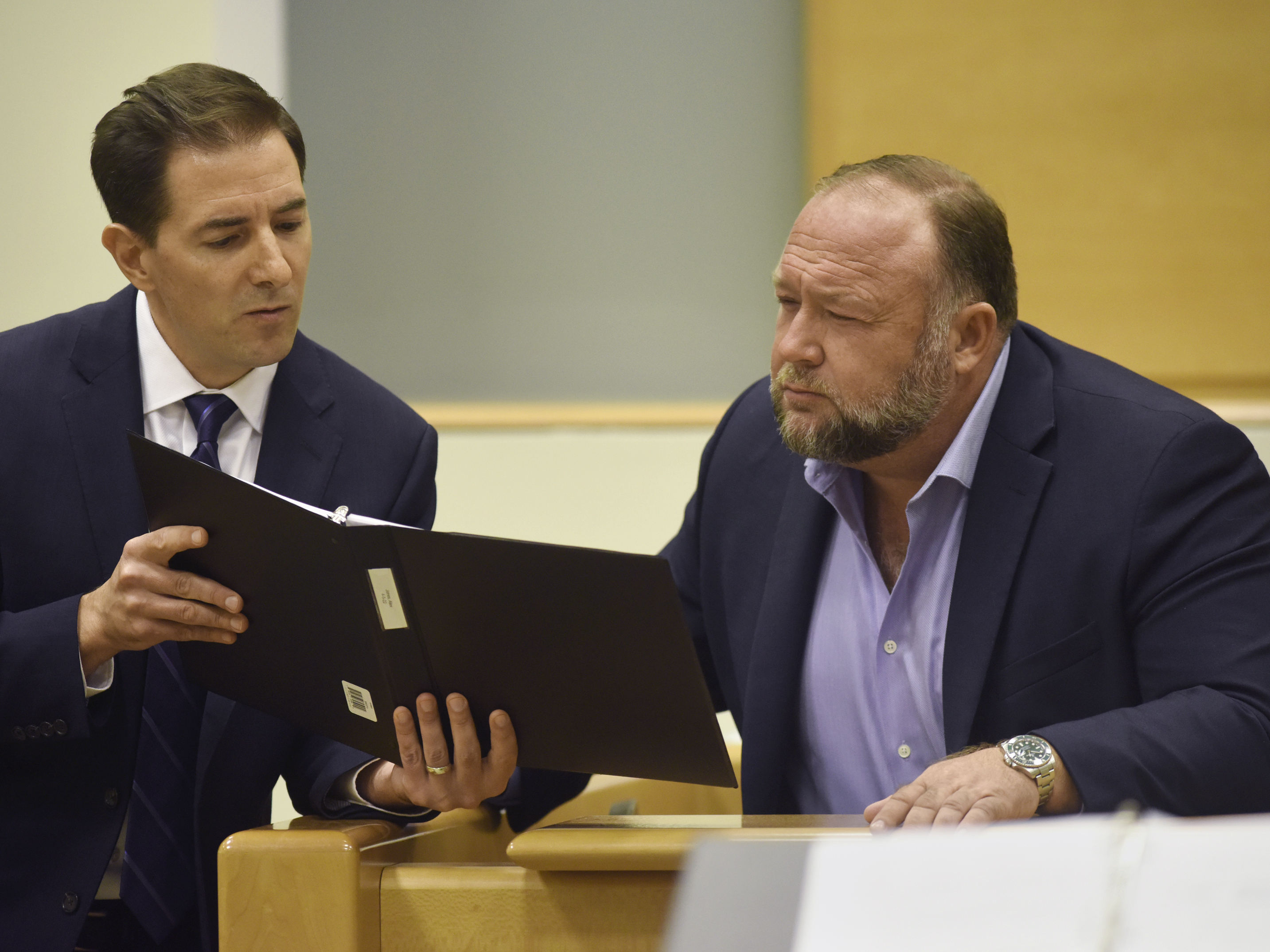 caption: Plaintiff's attorney Chris Mattei (left) questions Alex Jones on Thursday at Jones' trial to determine defamation damages in Waterbury, Conn.