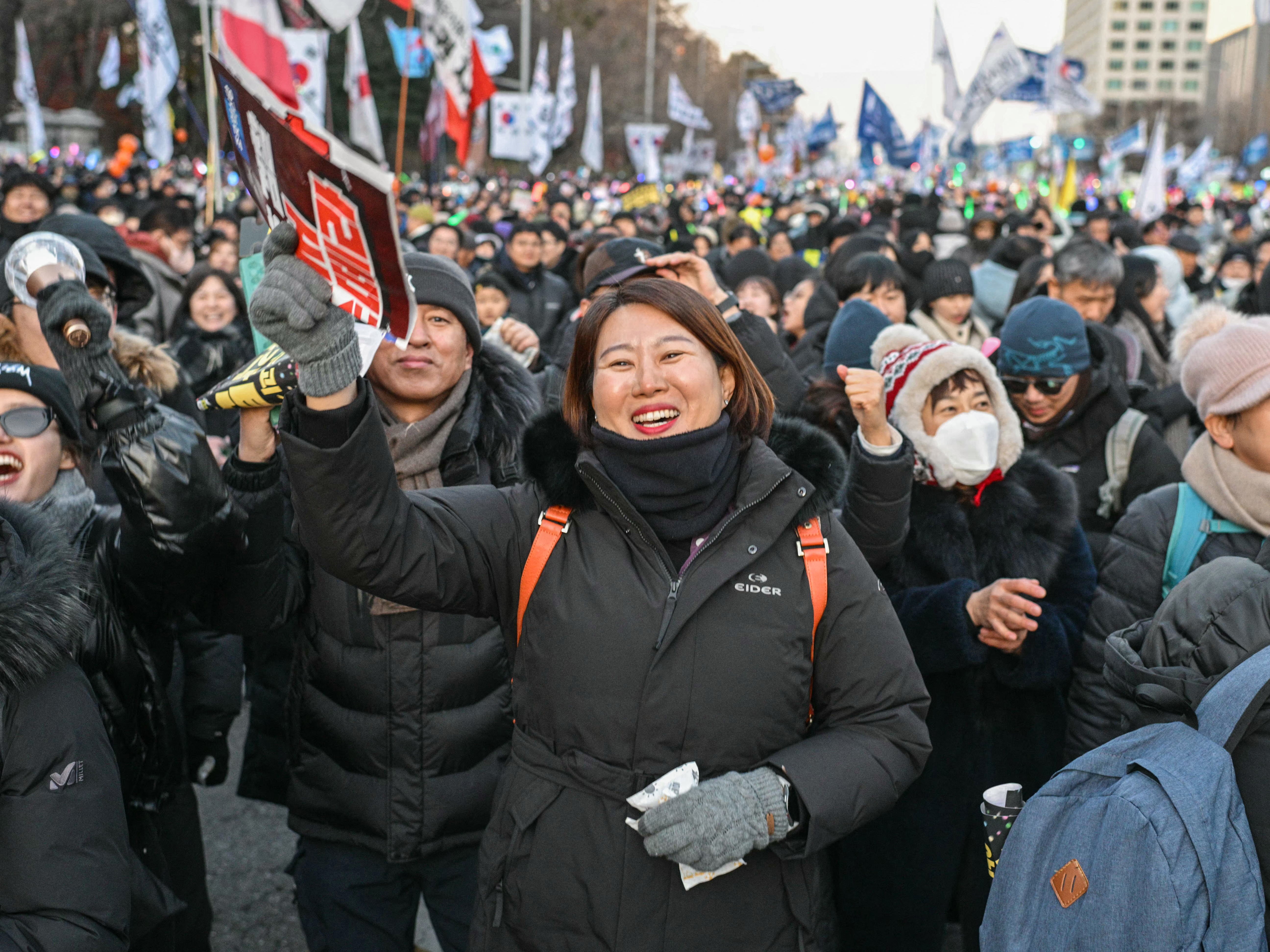 caption: Protesters calling for the ouster of South Korea President Yoon Suk Yeol react after the result of the second martial law impeachment vote outside the National Assembly in Seoul, on Saturday.