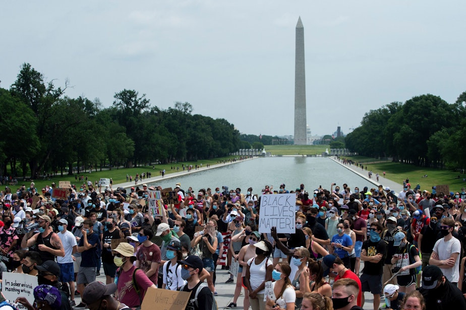 caption: Demonstrators protest at Lincoln Memorial near the Washington Monument (rear) during a protest against police brutality and racism, on June 6, 2020 in Washington, DC. (ROBERTO SCHMIDT/AFP via Getty Images)