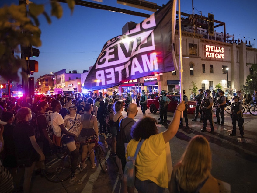 caption: Protesters face police on June 6 in Minneapolis as they demand justice for Winston Boogie Smith Jr., who was fatally shot by members of a U.S. Marshals Fugitive Task Force. A woman at another Smith protest was killed Sunday after a vehicle drove into demonstrators.