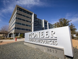 caption: Pioneer Natural Resources' office is shown on Jan. 13, 2021, in Midland, Texas. Exxon Mobil's $60 billion deal to buy Pioneer has received clearance from the Federal Trade Commission, but the former CEO of Pioneer was barred from joining the new company's board of directors.