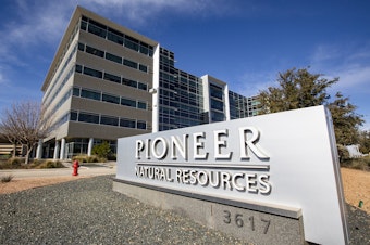 caption: Pioneer Natural Resources' office is shown on Jan. 13, 2021, in Midland, Texas. Exxon Mobil's $60 billion deal to buy Pioneer has received clearance from the Federal Trade Commission, but the former CEO of Pioneer was barred from joining the new company's board of directors.