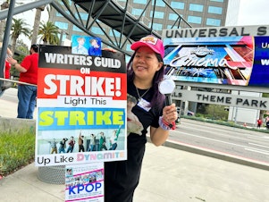 caption: Teresa Huang is a member of the WGA and SAG-AFTRA. She organized a special K-pop day at the picket line outside Universal Studios this week.