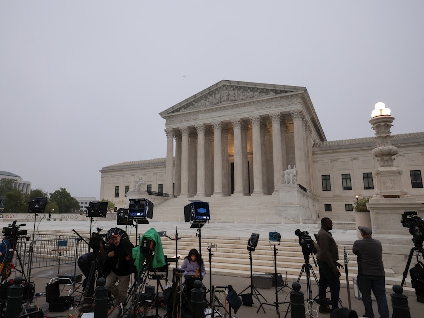 caption: TV camera crews station in front of the Supreme Court building on Tuesday in Washington, D.C.