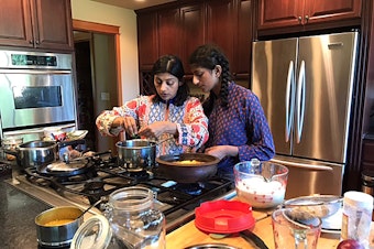 caption: Neelima Musaliar (L) learned to cook as a prerequisite for an arranged marriage. Now she's teaching her daughter Aliyah (R) to cook to show her that she doesn't need to stir the pot for anyone other than herself. 