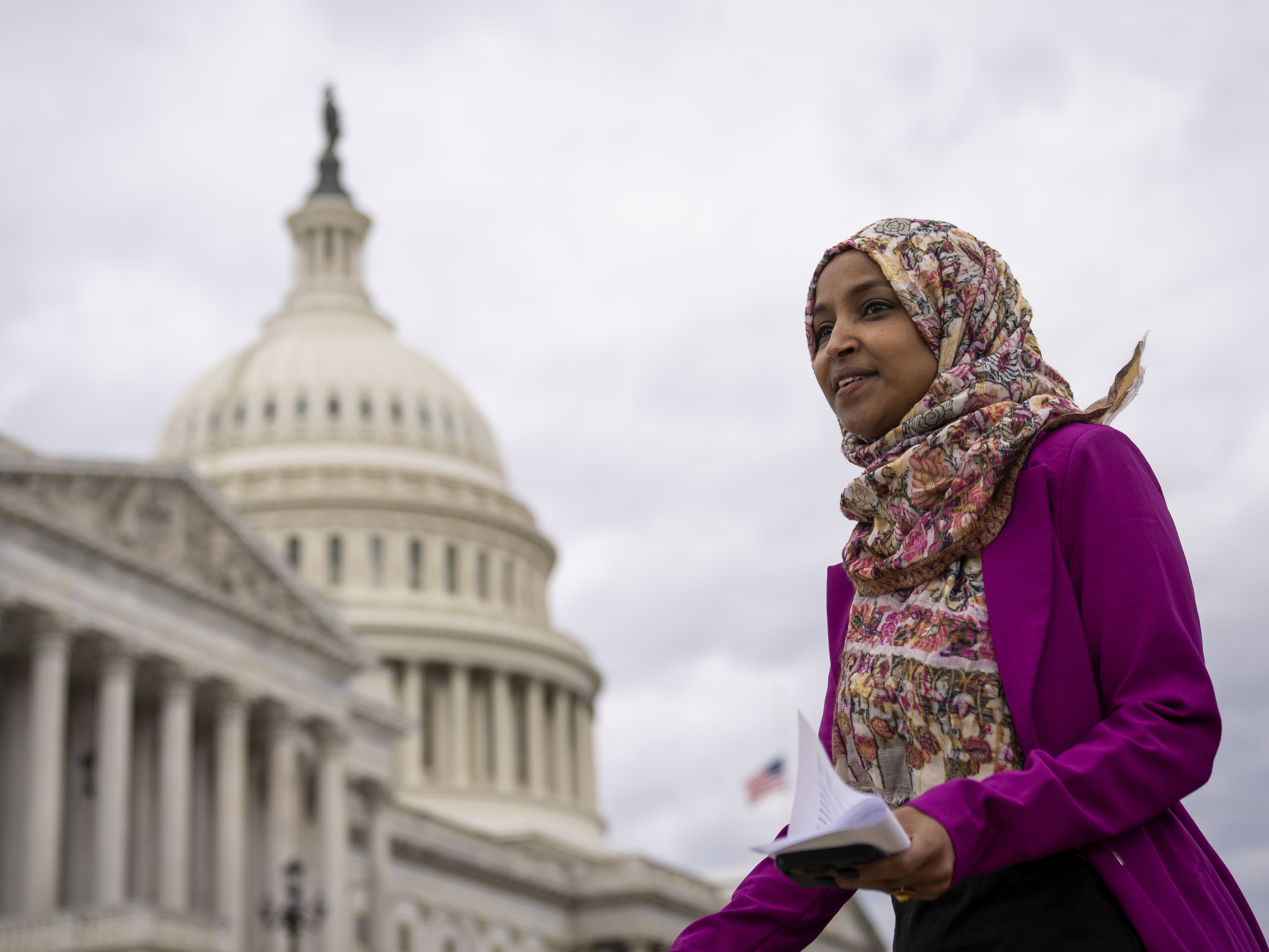 caption: Rep. Ilhan Omar, D-Minn., departs a news conference outside the U.S. Capitol on Jan. 26.