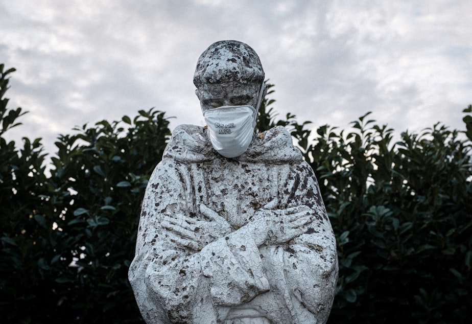 caption: A face mask adorns a statue of St. Francis of Assisi in the town of San Fiorano, one of the places in Italy on lockdown due to the novel coronavirus outbreak. The picture was taken by schoolteacher Marzio Toniolo.