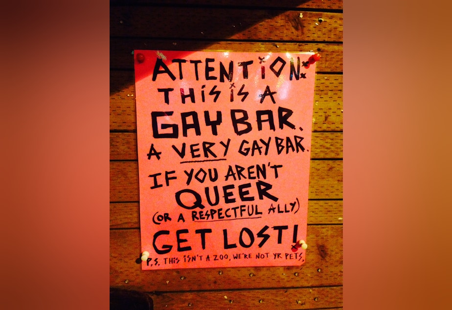 caption: The sign in front of Pony lets new patrons on Capitol Hill know what to expect.