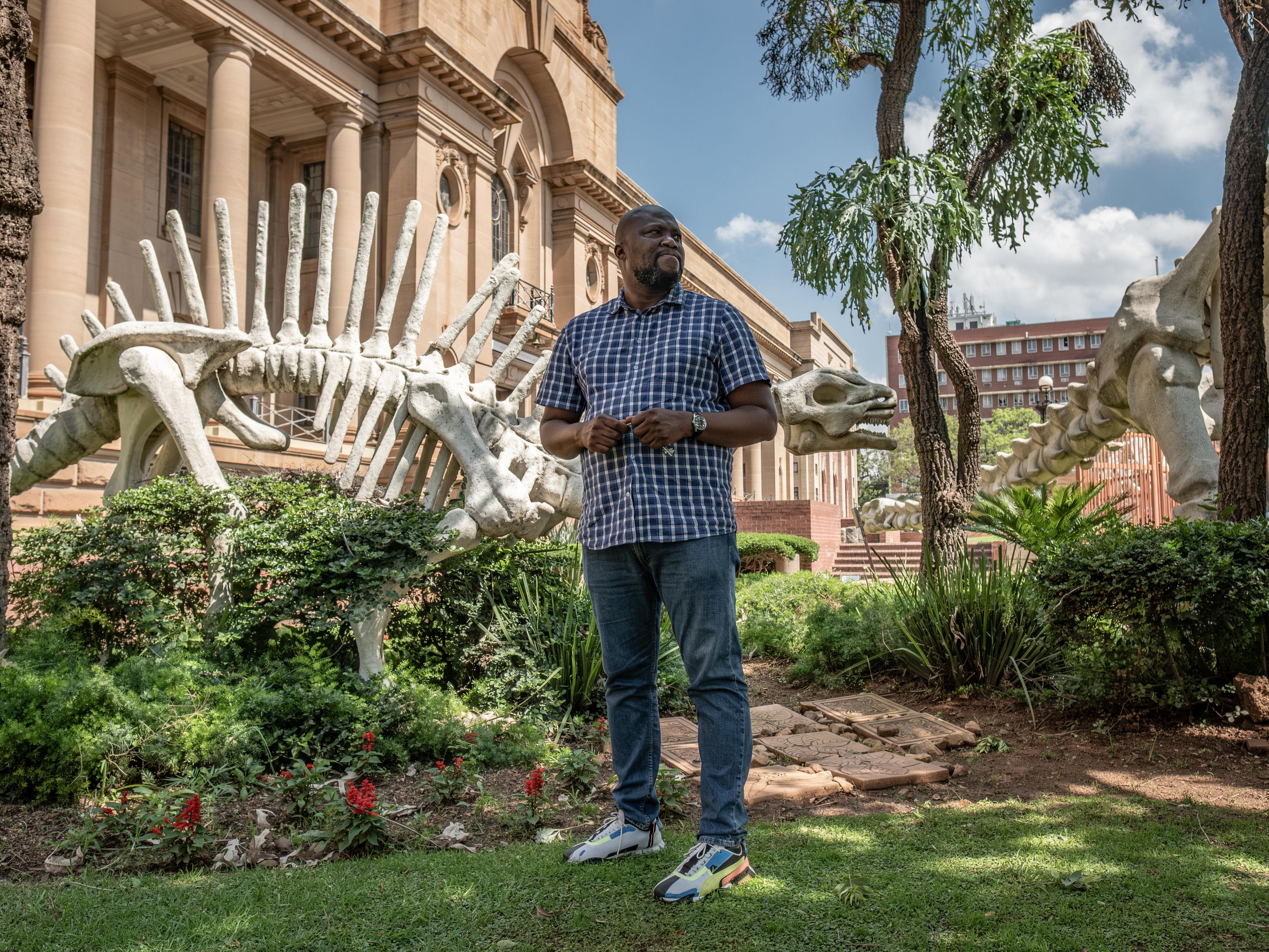 caption: Lazarus Kgasi entered the orbit of paleontology on a whim. After high school, he needed to support his family. He worked a couple of odd jobs before he was hired as a fossil digger. It would forever change his life.