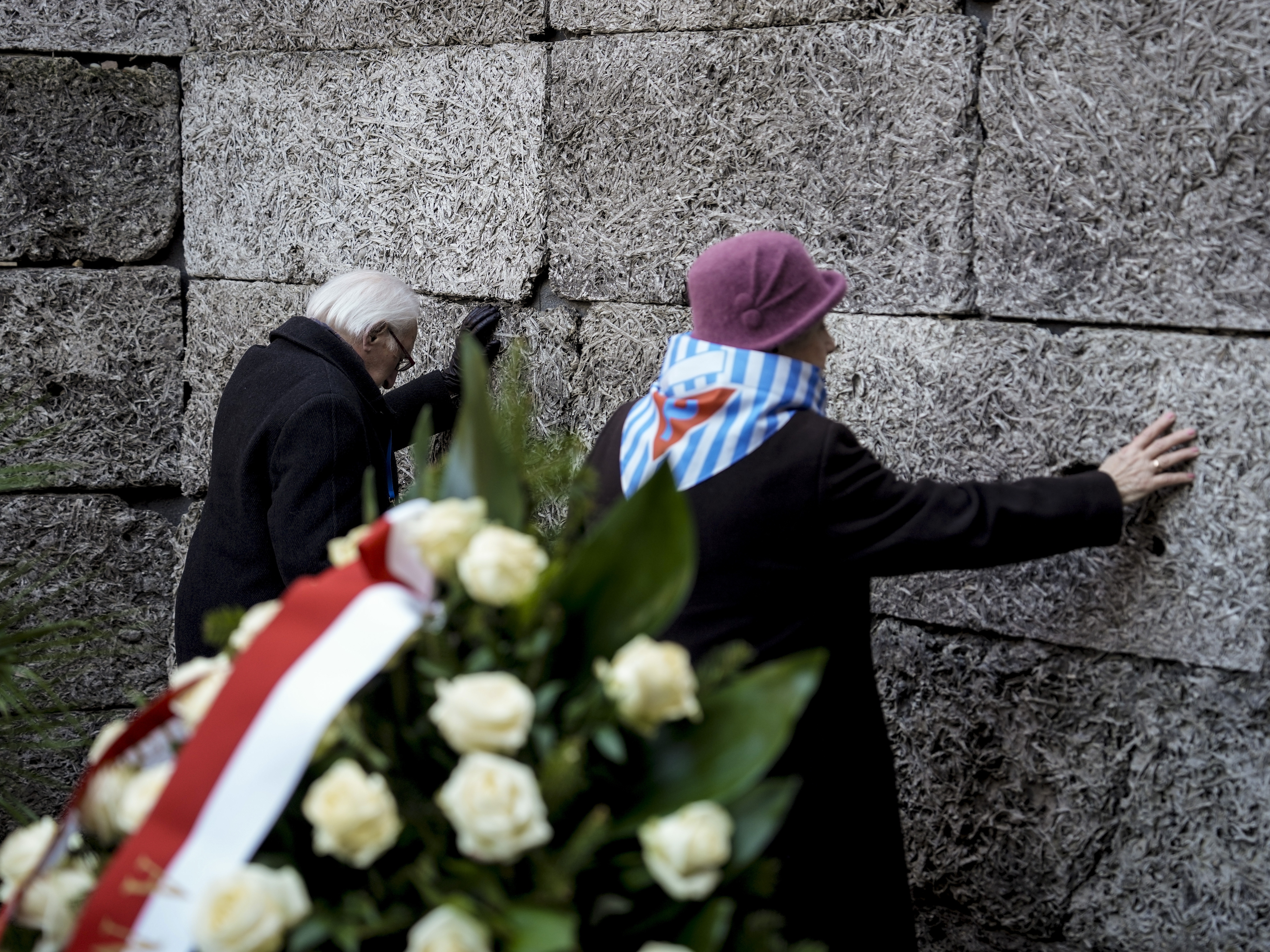 caption: Survivors and relatives attend a ceremony at the Auschwitz-Birkenau former Nazi German concentration and extermination camp, in Oswiecim, Poland, Monday, Jan. 27. 2025.