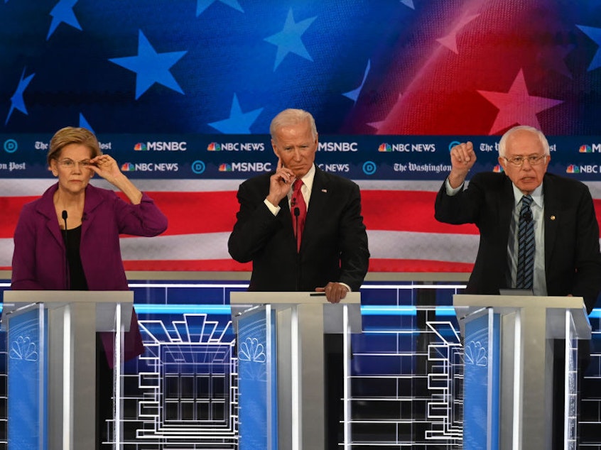 caption: Democratic presidential candidates debate on stage including Sen. Elizabeth Warren, D-Mass., (left) Former vice president Joe Biden and Sen. Bernie Sanders, I-Vt., (right).