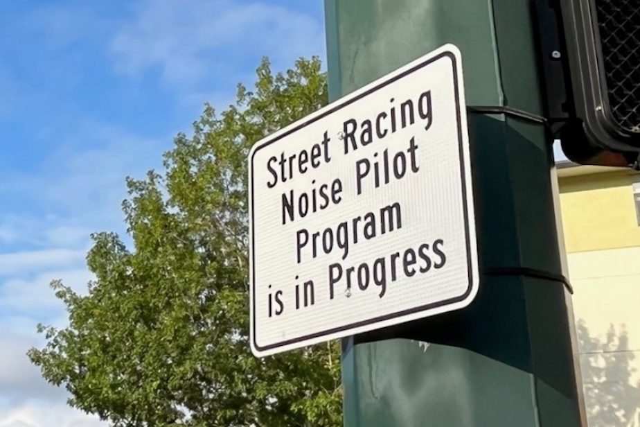 caption: A sign in Kirkland alerting drivers to experimental cameras designed to capture loud vehicle noises and street racers. 