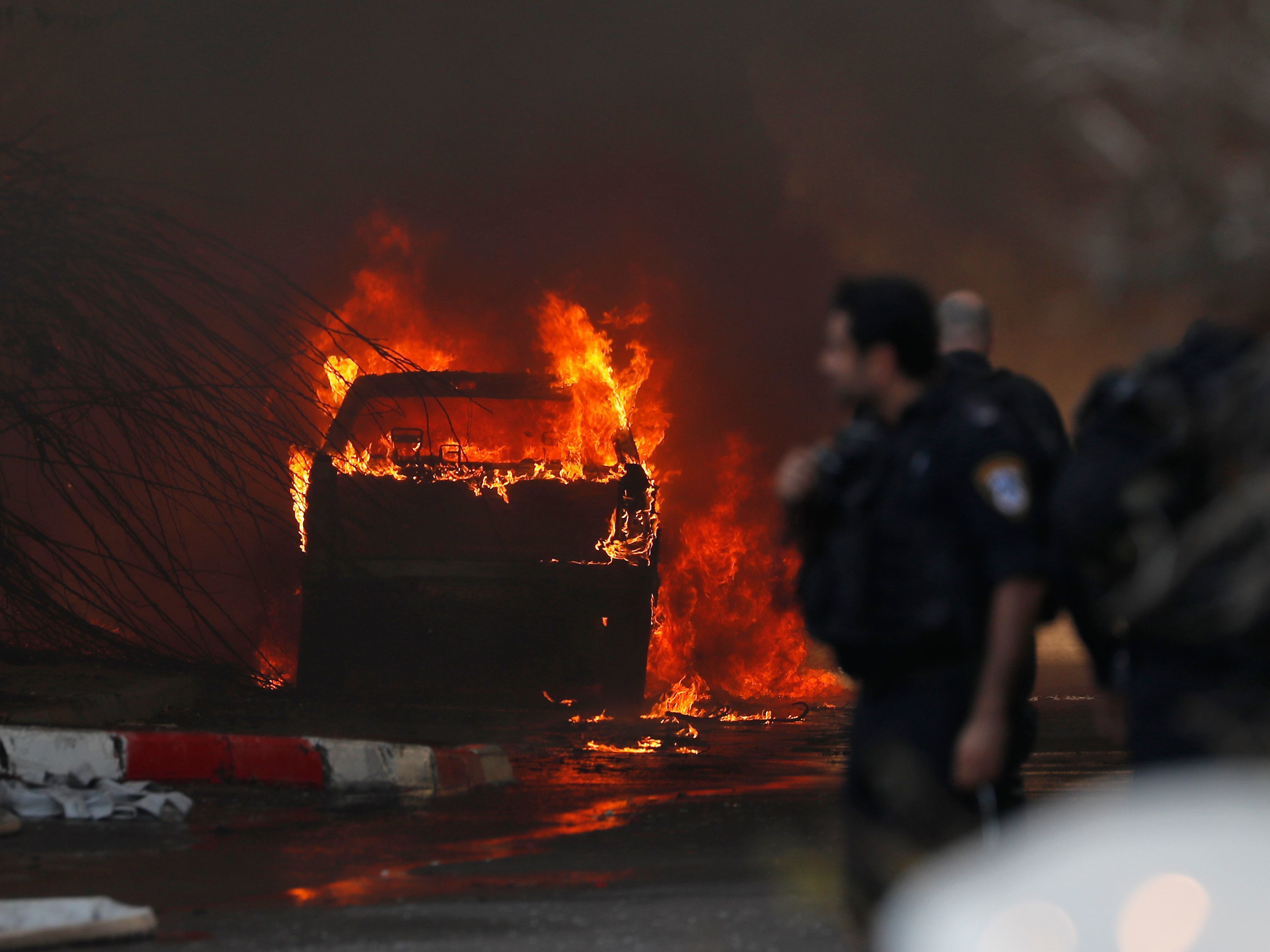 caption: A vehicle burns outside a factory that was apparently hit with rocket fire Tuesday in the southern Israeli town of Sderot. Israel's military announced it had killed a commander of the Palestinian militant group Islamic Jihad in an early morning strike on his home in the Gaza Strip, prompting retaliatory barrages from Gaza.