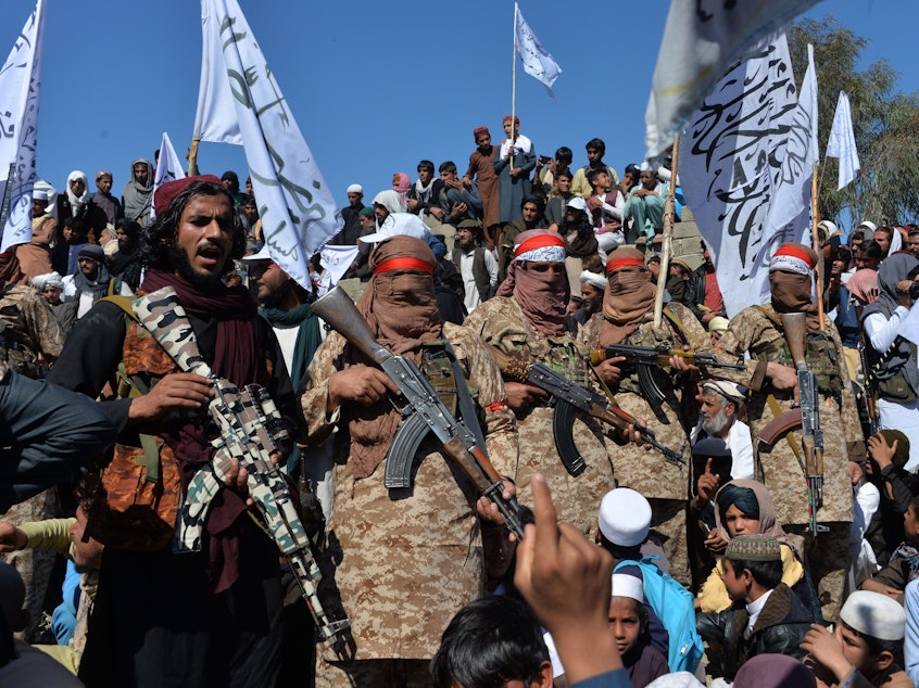 caption: Militants linked with the Afghan Taliban gather Monday for a ceremony in Laghman province, celebrating the agreement the group signed with the U.S. over the weekend. Since the deal was announced, the Taliban has resumed its attacks in Afghanistan.