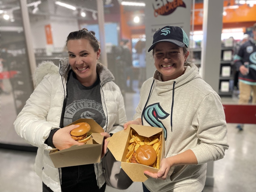 caption: Courtney Fisher (R) and her friend braved the line and got their Kraken Chicken Sandwiches