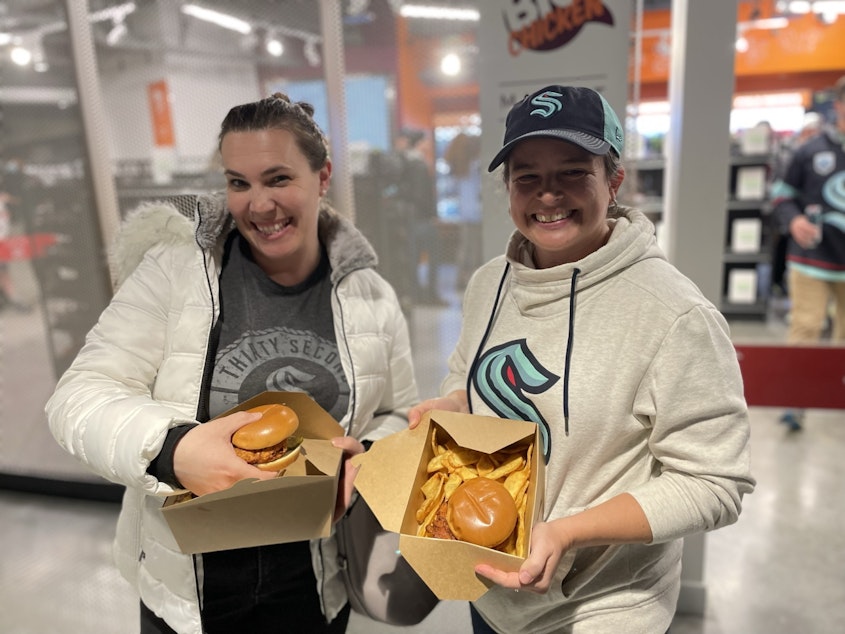 caption: Courtney Fisher (R) and her friend braved the line and got their Kraken Chicken Sandwiches