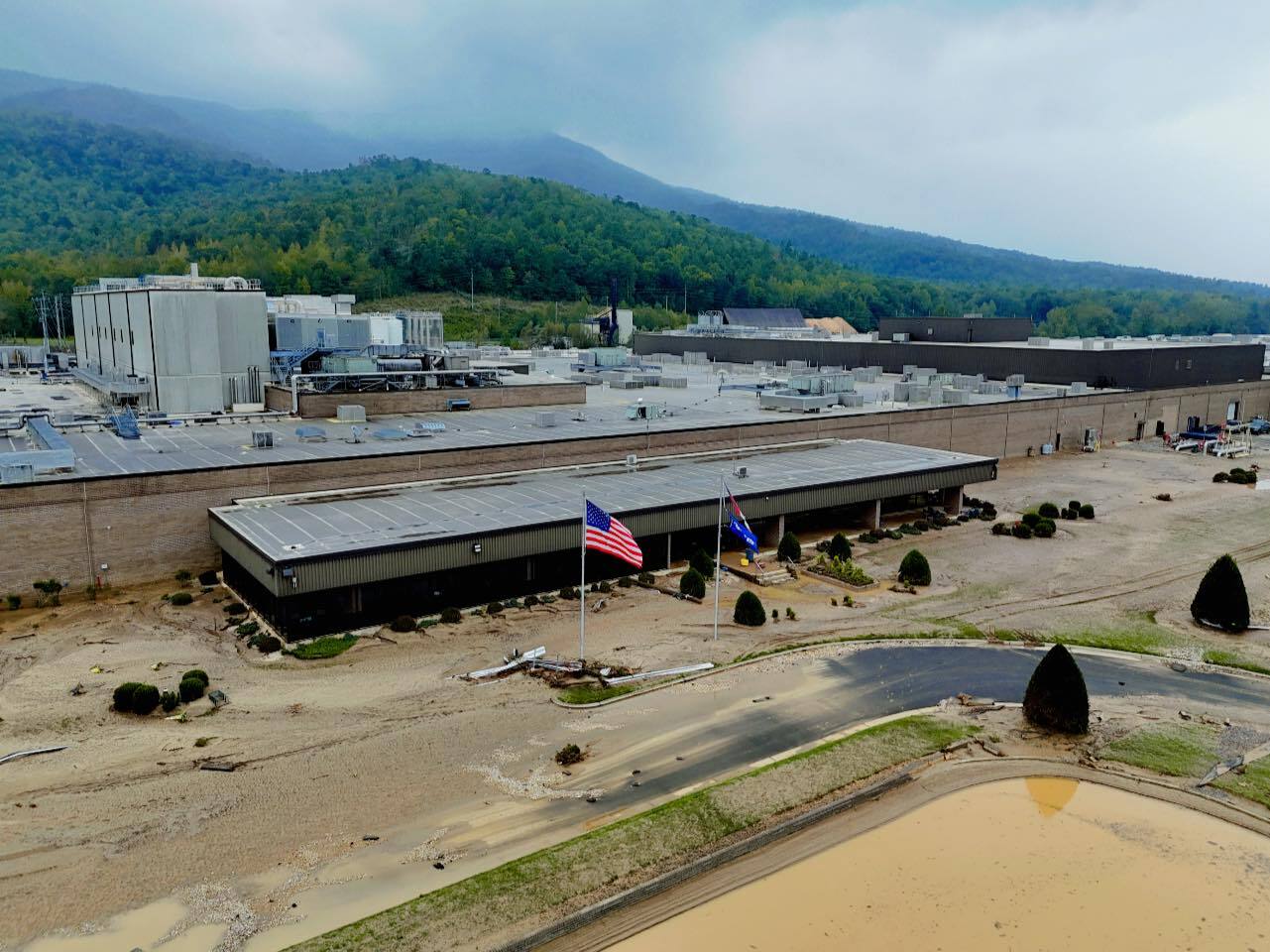 caption: Footage from Sept. 28 shows sand and debris left after flooding shut down operations at Baxter International's facility in Marion, N.C. The plant is the largest manufacturer of intravenous and peritoneal dialysis solutions in the United States.