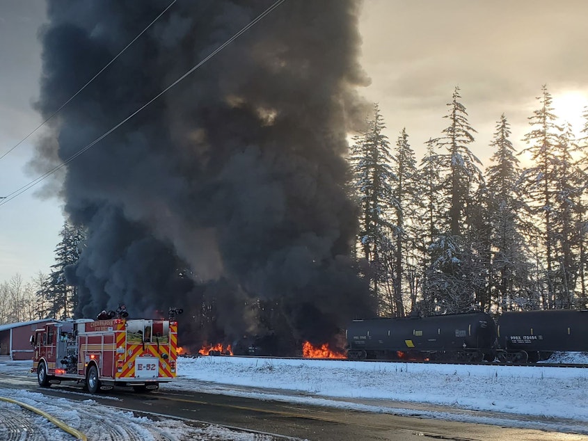 caption: Bakken crude oil fire sends up black smoke from a derailed train in Custer, Washington, on Dec. 22, 2020.