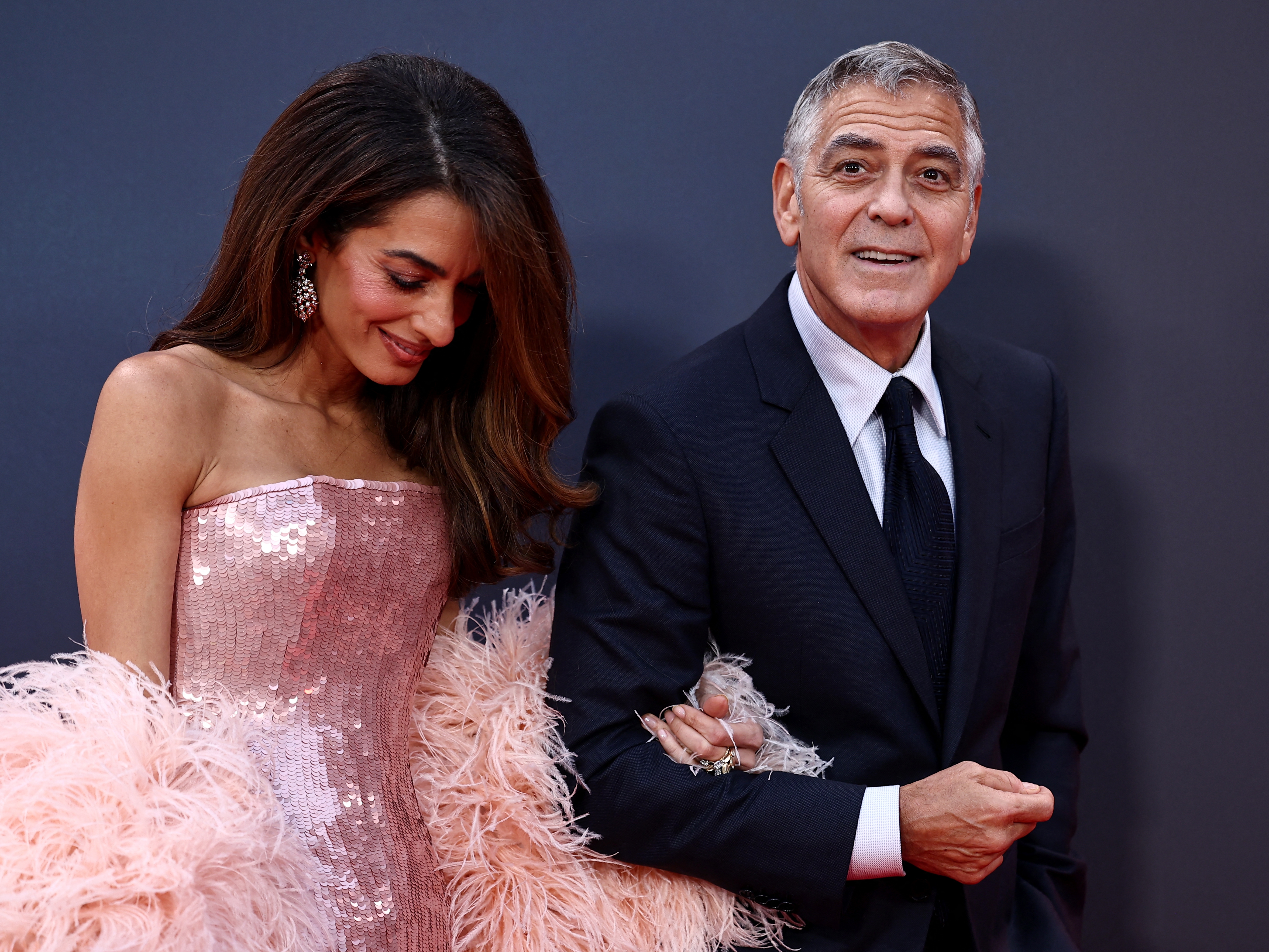 caption: The French government confirmed this week that it has granted citizenship to George and Amal Clooney — pictured on a London red carpet in October — and their 7-year-old twins.