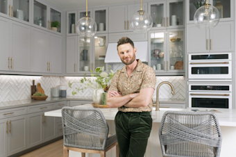 caption: Interior designer Bobby Berk for "Queer Eye" fame stands in a model home for Tri Pointe Homes. Berk partnered with the developer on home designs. The first model homes bearing Berk's designs in Pierce County opened at a Bonney Lake development in April 2024. 