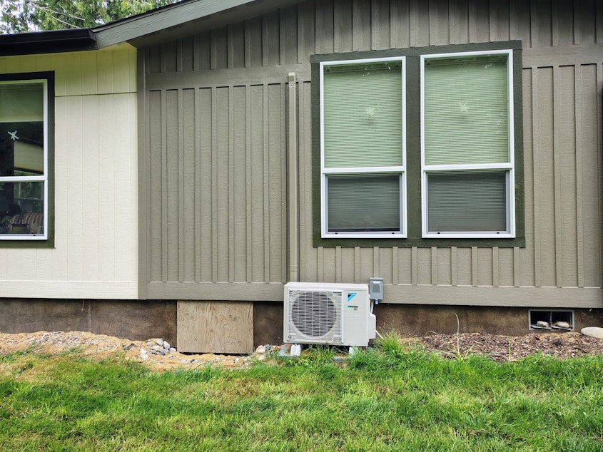 caption: A heat pump warms farmer Martin Vandepas' home in Greenbank, Washington, on May 20, 2025.