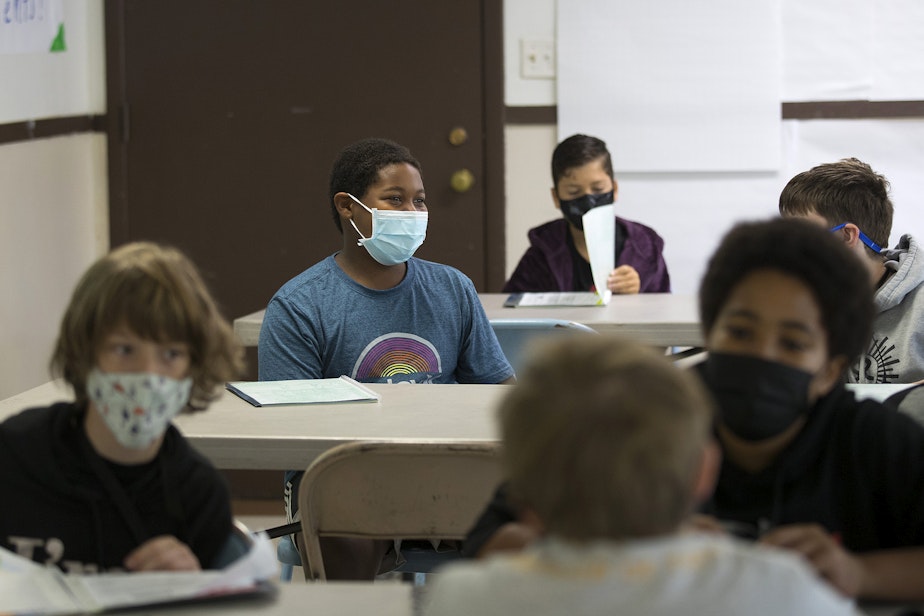 caption: Seattle School for Boys 6th-grade student Ari Elbert, center, laughs while talking with a classmate on the first day of school on Monday, September 13, 2021, in Seattle.