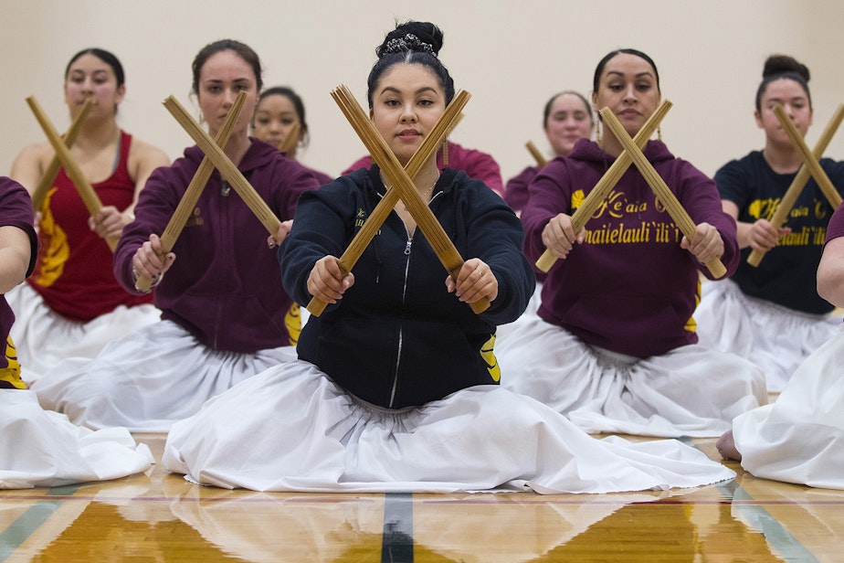 caption: Jessica Whalen, center, practices their traditional Kahiko dance along with the rest of the dancers on Wednesday, Feb. 28, 2018, at Washington High School in Parkland.