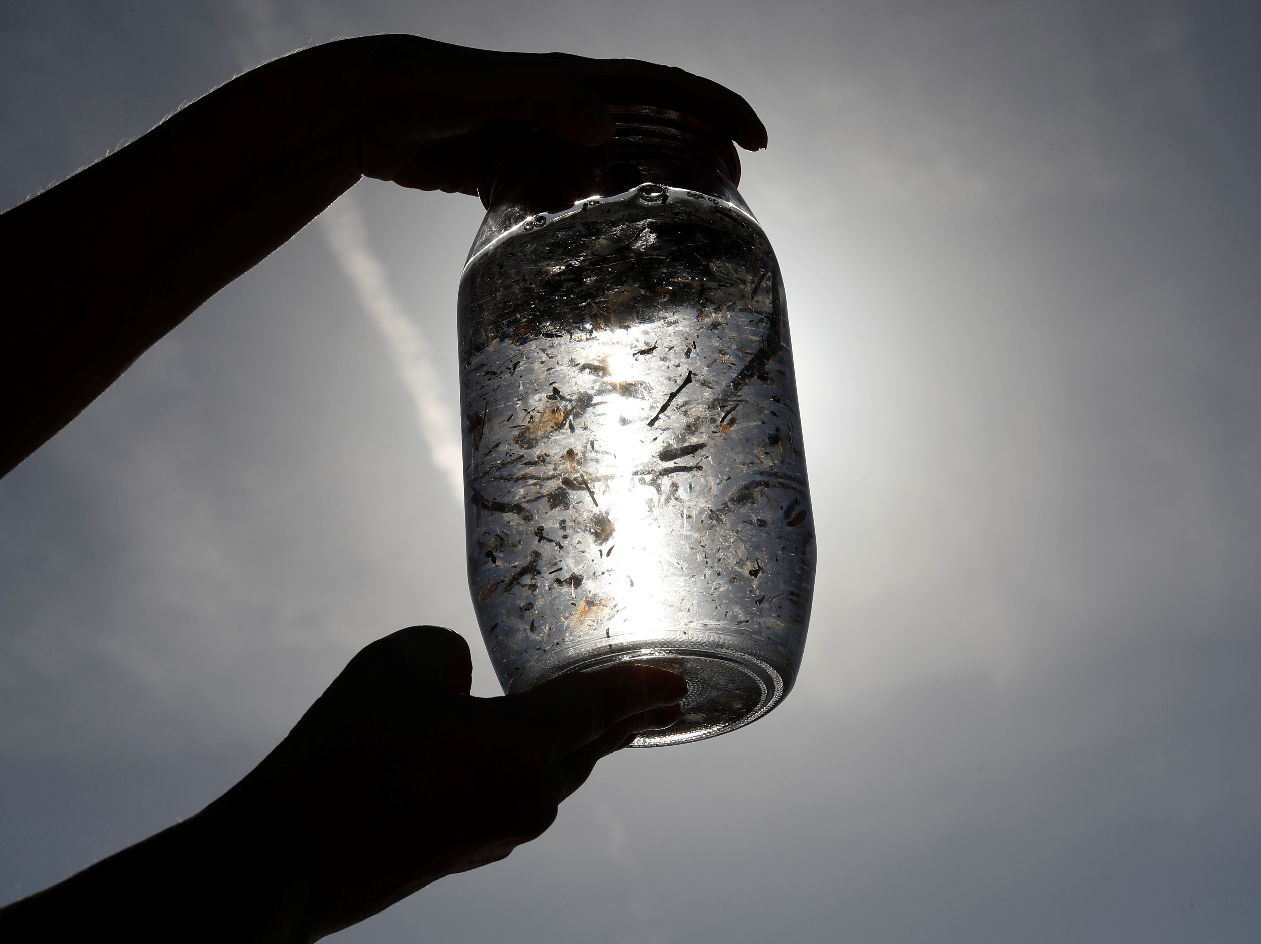 caption: A water sample taken from the Mediterranean Sea as part of a scientific study about microplastics damaging marine ecosystems on the French Riviera in 2018. In a new study, the WHO says that microplastics are "ubiquitous."