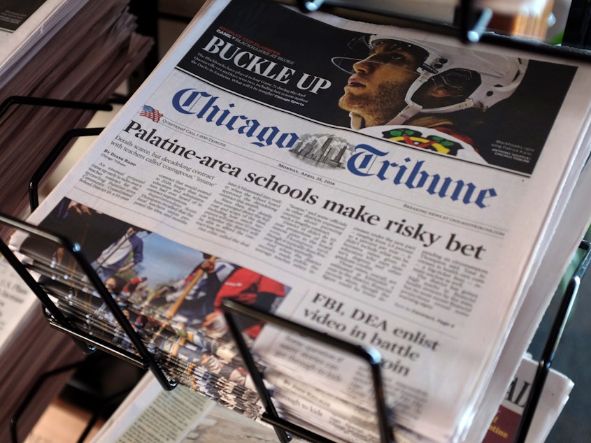 caption: Tribune Publishing, the owner of the <em>Chicago Tribune</em> as well as the New York <em>Daily News</em>, <em>The Baltimore Sun</em> and other newspapers, is cutting pay and asking journalists to take furloughs at many of these newsrooms.