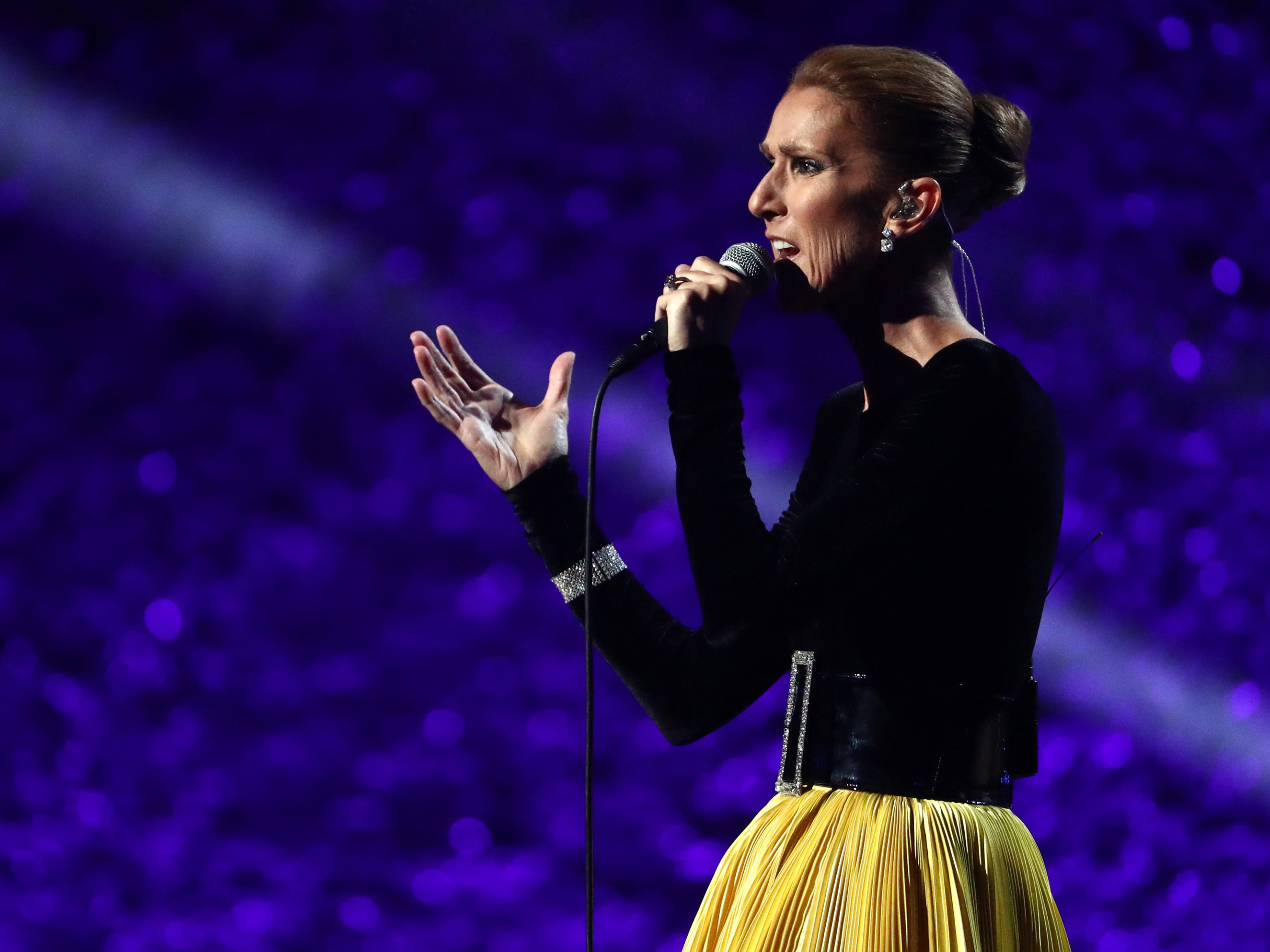 caption: Céline Dion performing in 2019, the year her world tour was original scheduled to begin. It has since been delayed repeatedly, first due to the pandemic and then because of muscle spasms that have now been diagnosed as stiff-person syndrome.