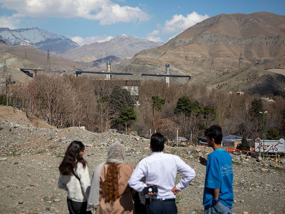 caption: People view the damaged B1 bridge, a day after it was destroyed by an airstrike, on April 3, 2026 west of Tehran in Karaj, Iran.
