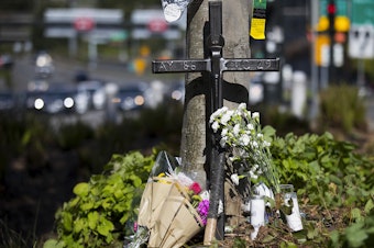 caption: A memorial is shown near the scene of the fatal crane collapse on Monday, April 29, 2019, on Mercer Street in Seattle.