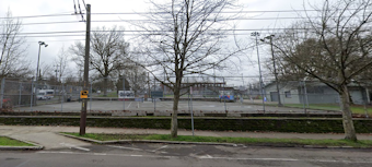 caption: Migrants from Venezuela and Angola descended on the tennis courts near the Garfield Community Center in Seattle on April 2, 2024. They stayed one night before an anonymous donor put forth $50,000 to pay for hotel rooms for them to stay at in Kent.