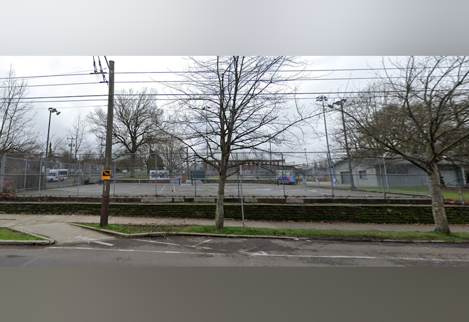 caption: Migrants from Venezuela and Angola descended on the tennis courts near the Garfield Community Center in Seattle on April 2, 2024. They stayed one night before an anonymous donor put forth $50,000 to pay for hotel rooms for them to stay at in Kent.