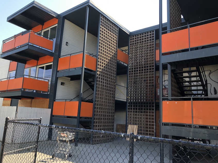 caption: The apartment building at 1725 Barton Street SW in Seattle still sits vacant after a tenant started a fire on Feb. 12, 2023. 