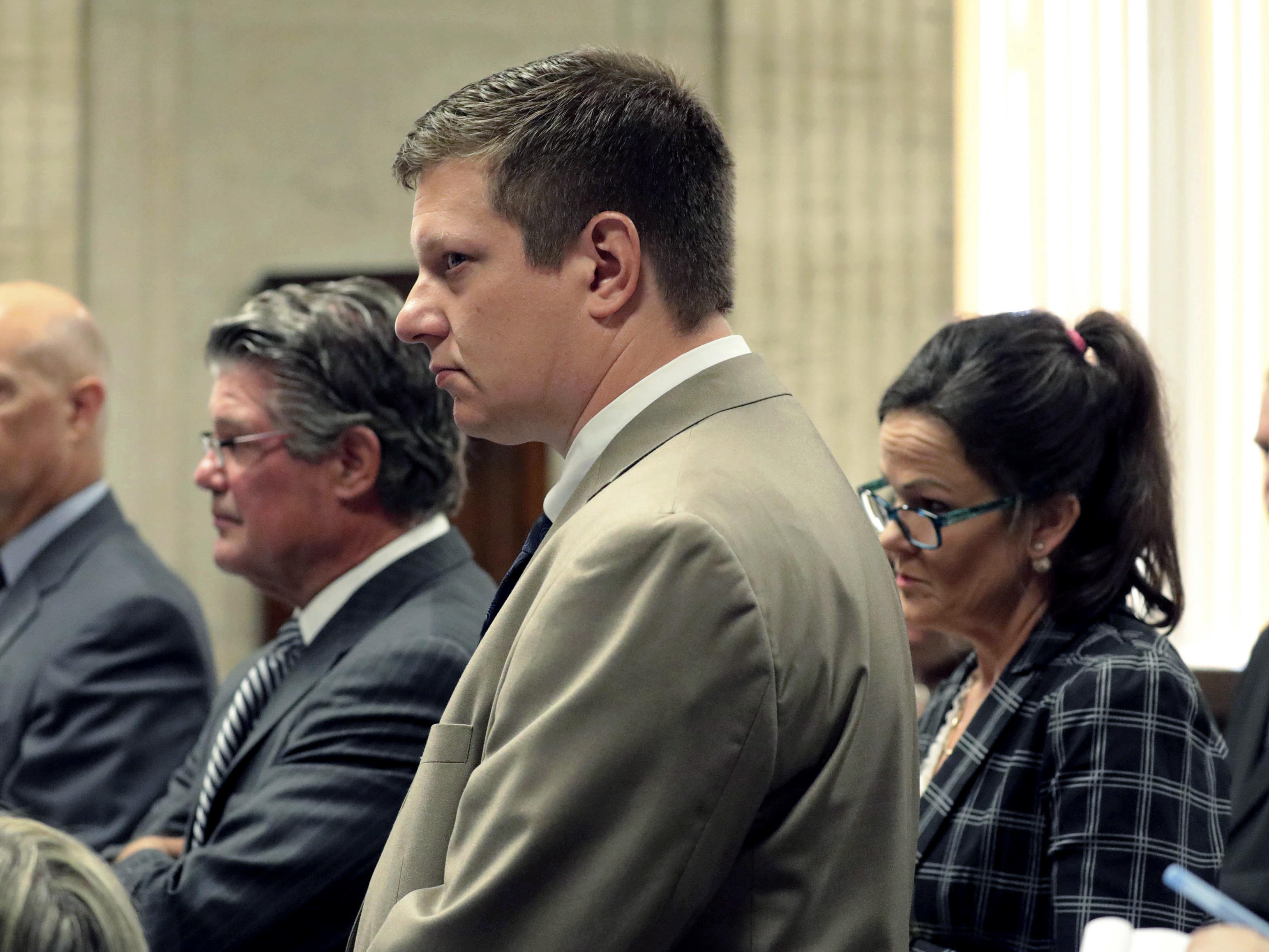 caption: Chicago police Officer Jason Van Dyke, center, attends a hearing at the Leighton Criminal Court Building, in Chicago. Jury selection begins today in Van Dyke's murder trial for the 2014 fatal shooting of 17-year-old Laquan McDonald.