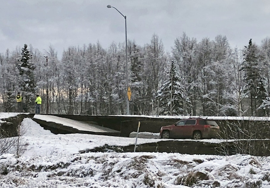 caption: A car is trapped on a collapsed section of the offramp off of Minnesota Drive in Anchorage, Friday, Nov. 30, 2018. Back-to-back earthquakes measuring 7.0 and 5.8 rocked buildings and buckled roads Friday morning in Anchorage, prompting people to run from their offices or seek shelter under office desks, while a tsunami warning had some seeking higher ground. 