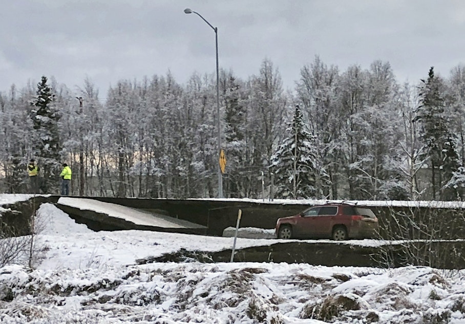 caption: A car is trapped on a collapsed section of the offramp off of Minnesota Drive in Anchorage, Friday, Nov. 30, 2018. Back-to-back earthquakes measuring 7.0 and 5.8 rocked buildings and buckled roads Friday morning in Anchorage, prompting people to run from their offices or seek shelter under office desks, while a tsunami warning had some seeking higher ground.