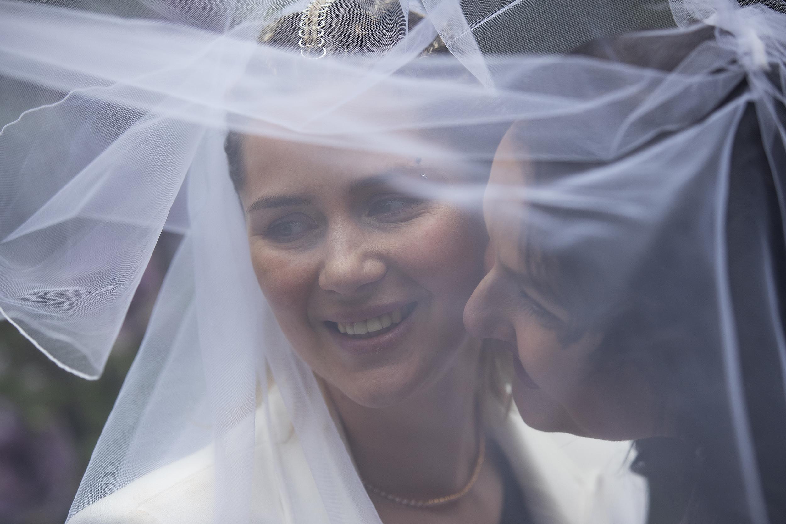 caption: Iryna, left, and Olena, smile for their photographer (not pictured) shortly after getting married on Saturday, April 8, 2023, at a home in Bellevue. 