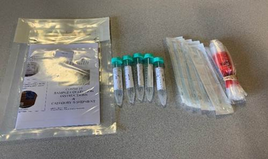 caption: A COVID-19 test kit. Washington Gov. Jay Inslee has instructed state health officials to test all nursing home staff and residents in the coming weeks, according to a state doctor.