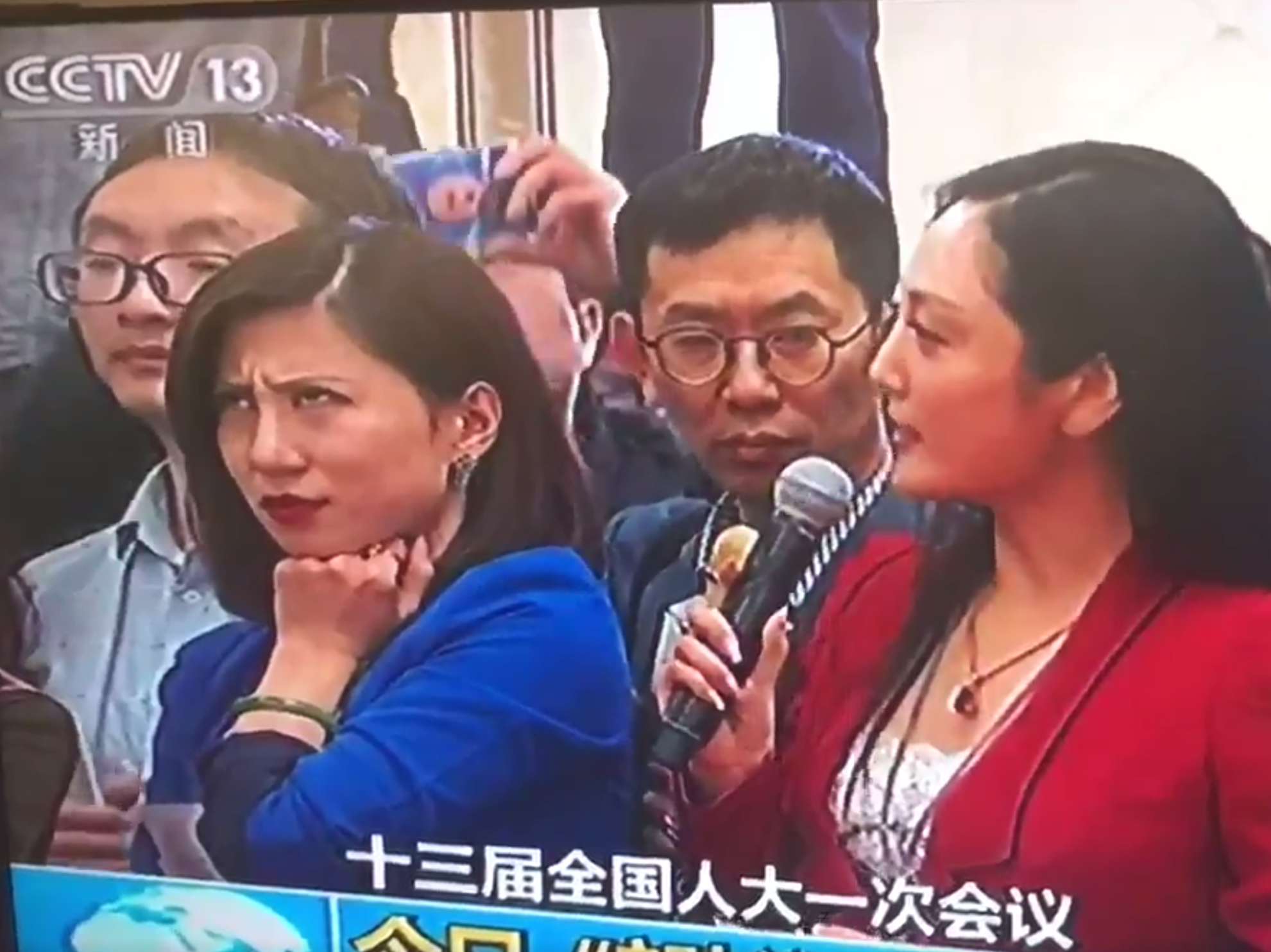 caption: A screenshot of Liang Xiangyi, a financial news reporter, who was so disgusted by a fellow reporter's softball question to a government official at the National People's Congress that she was caught on live television rolling her eyes. The moment went viral.