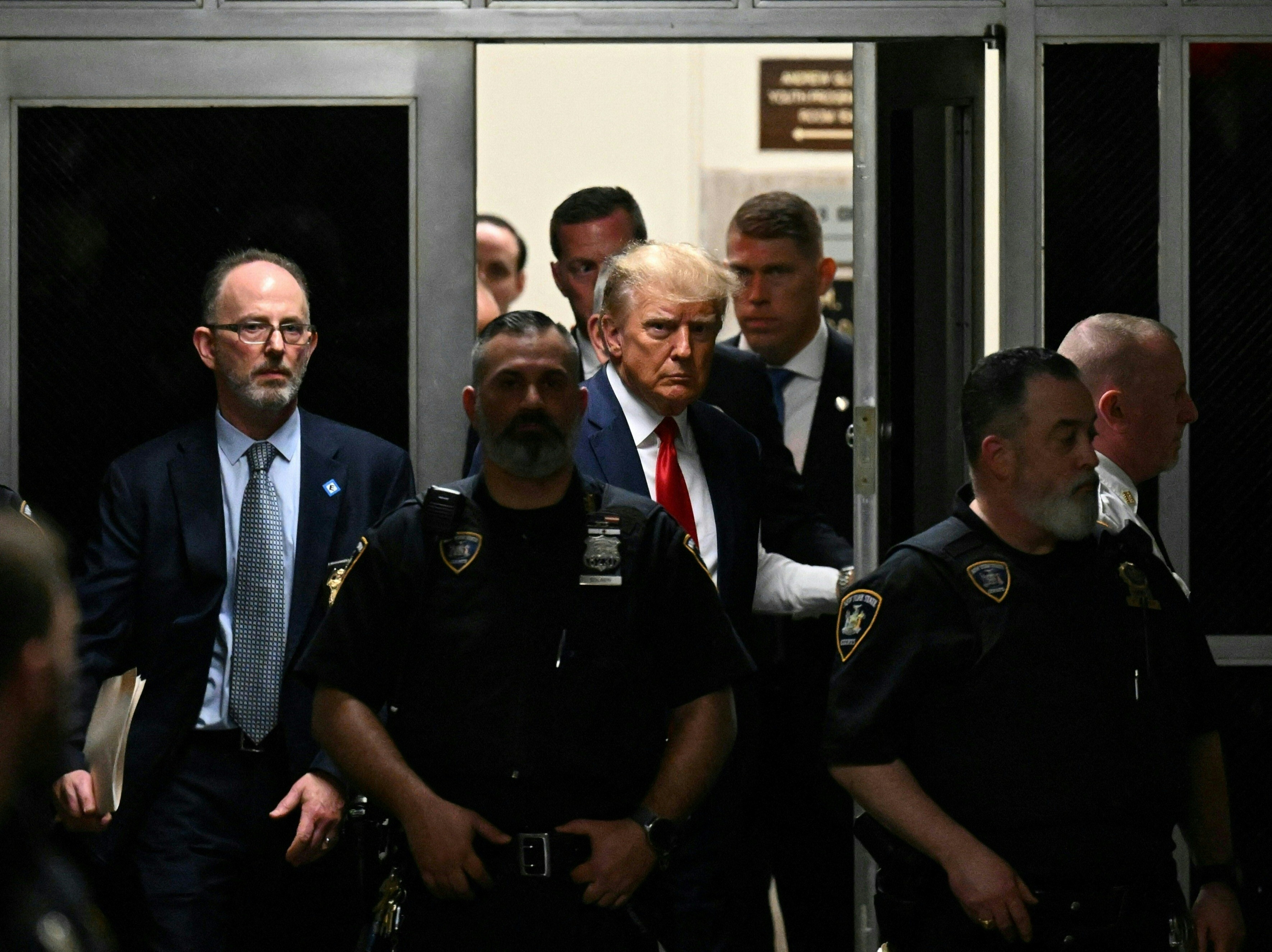 caption: Former US President Donald Trump makes his way inside the Manhattan Criminal Courthouse in New York on April 4, 2023.