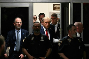 caption: Former US President Donald Trump makes his way inside the Manhattan Criminal Courthouse in New York on April 4, 2023.