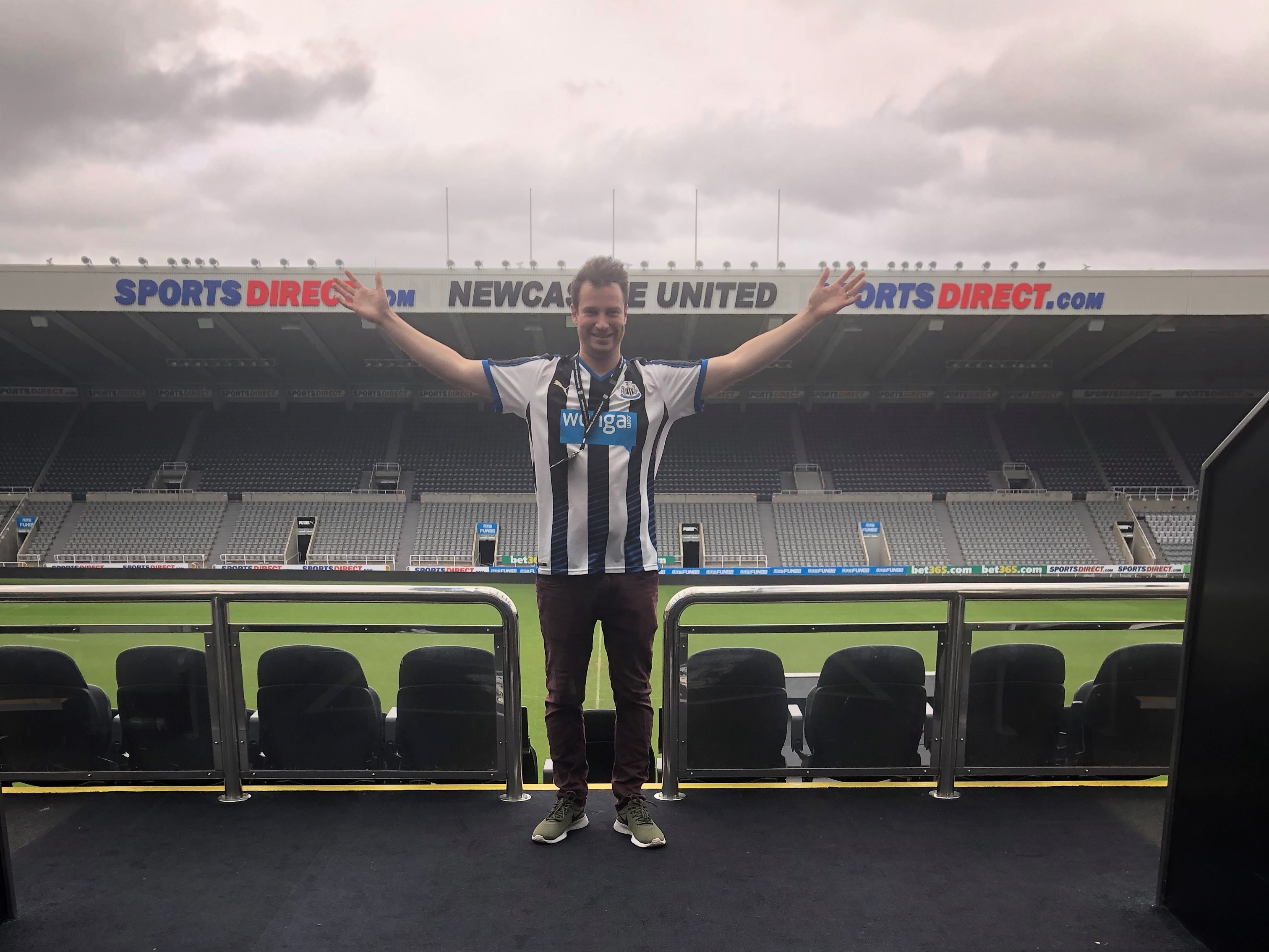 caption: Ty Malugani posing at St. James Park, the stadium of Premier League team Newcastle United in Newcastle upon Tyne, England.