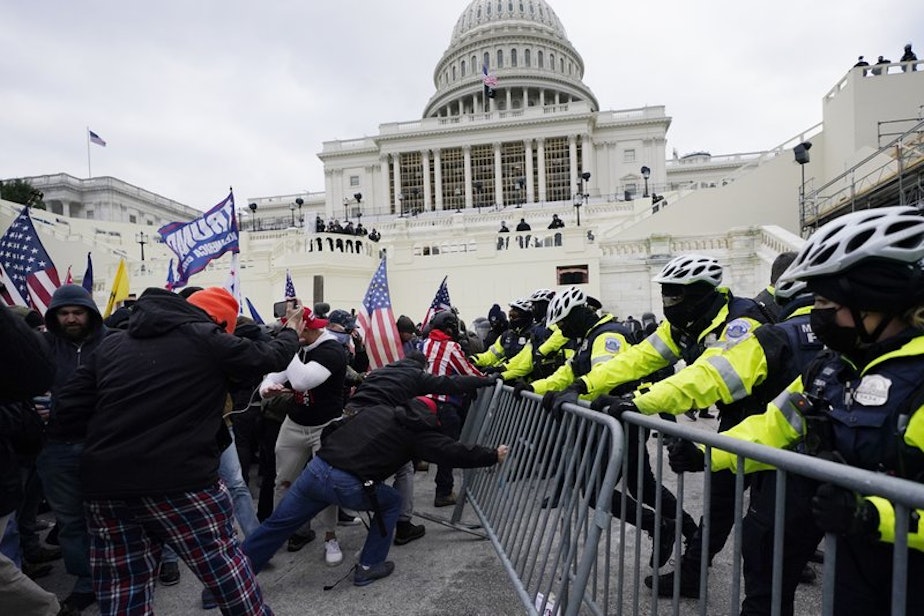caption: Trump supporters try to break through a police barrier, Wednesday, Jan. 6, 2021, at the Capitol in Washington. As Congress prepares to affirm President-elect Joe Biden's victory, thousands of people have gathered to show their support for President Donald Trump and his claims of election fraud.