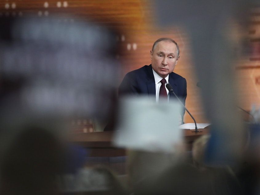caption: Russian President Vladimir Putin speaks Thursday during his annual news conference in Moscow. During the four-hour session, the longtime Russian leader called the U.S. impeachment process "far-fetched," making the prediction that Donald Trump will be acquitted in the Senate.