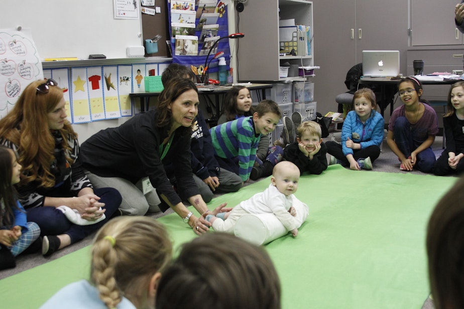 caption: Roots of Empathy instructor Rebecca Young and "teacher" baby Declan give a lesson at Highland Terrace Elementary School in Shoreline.