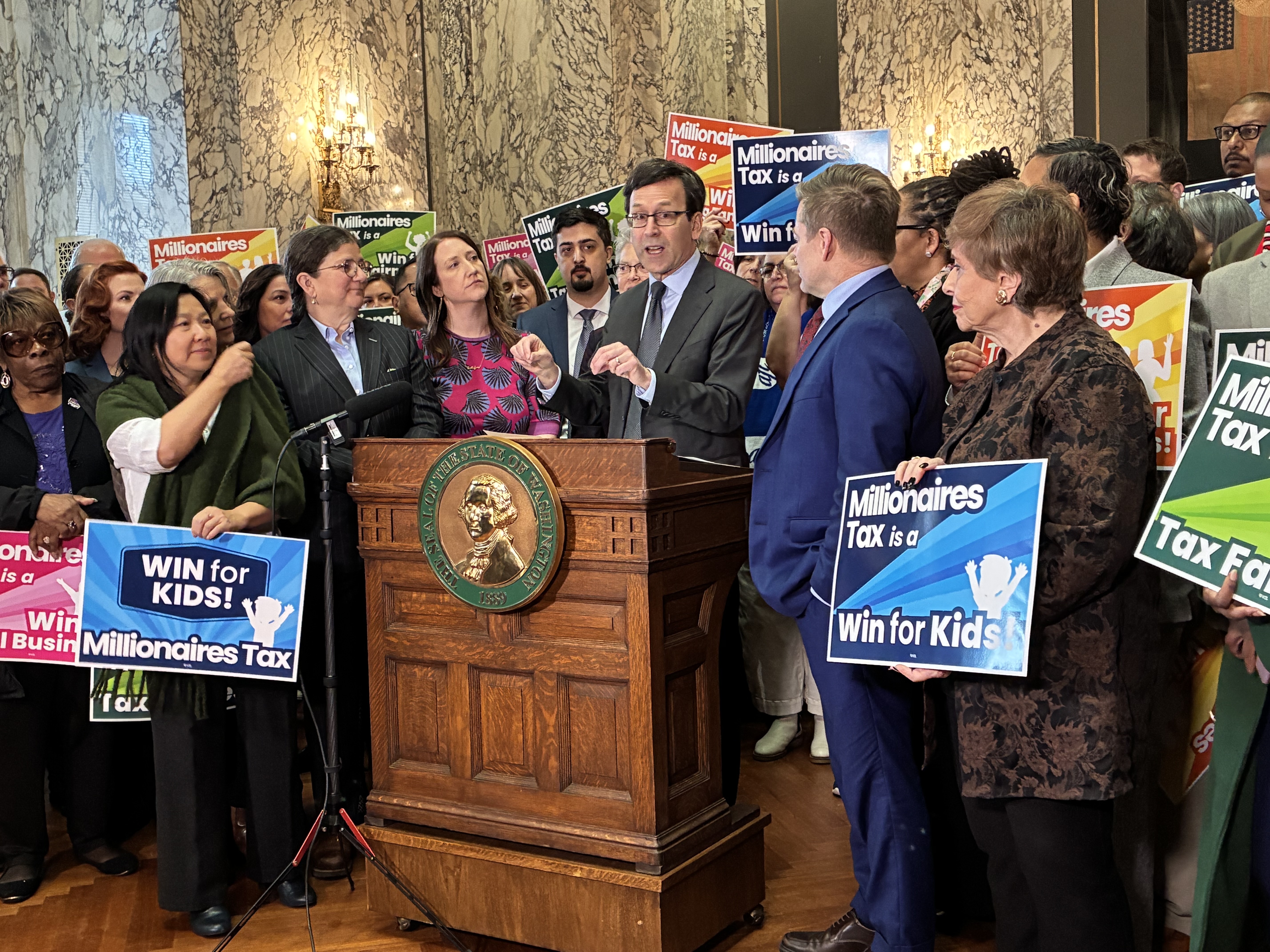 caption: Gov. Bob Ferguson signs Senate Bill 6346, also known as the "millionaires tax," into law on Monday, March 30, 2026.