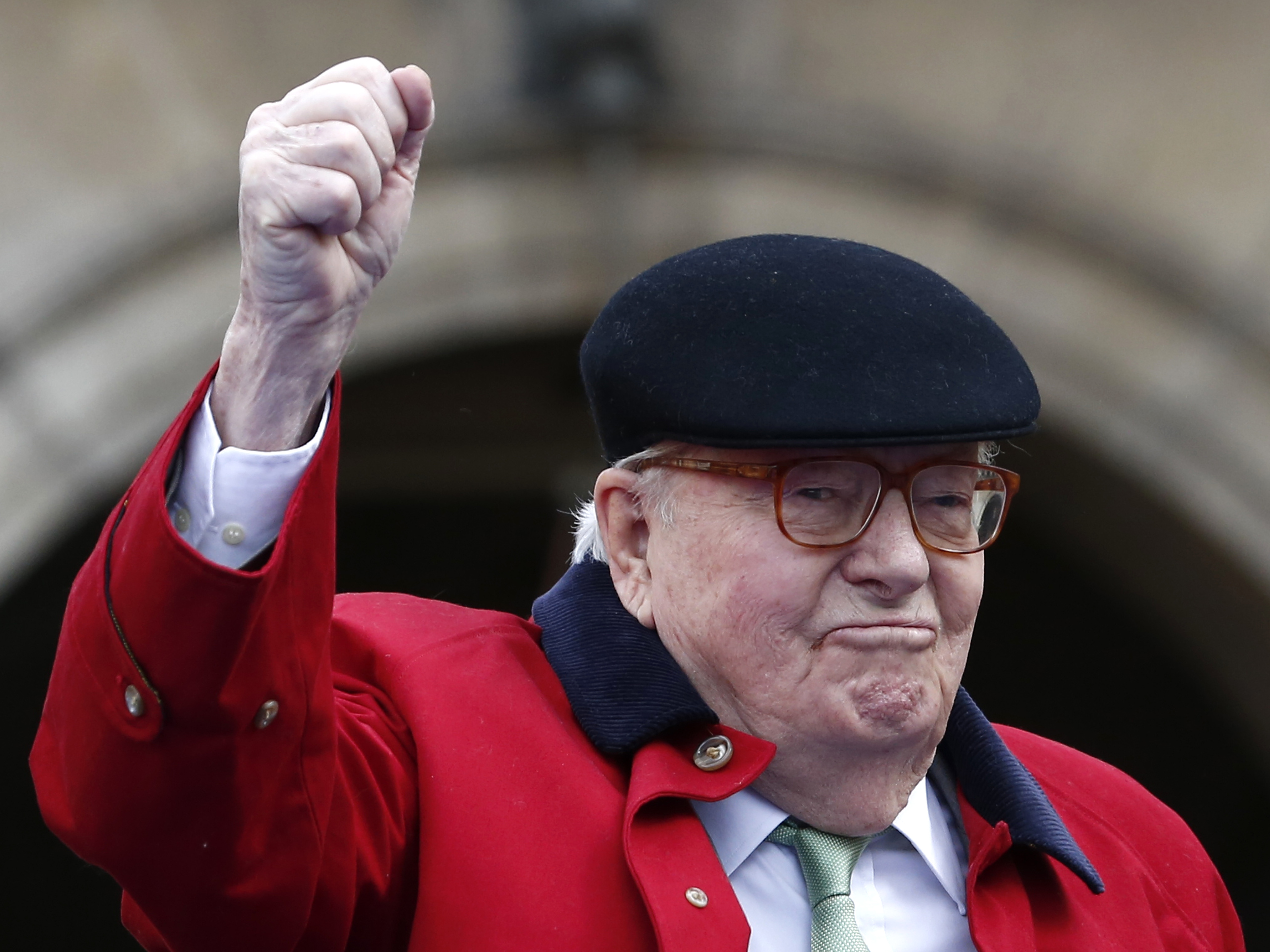 caption: Former far-right National Front party leader Jean-Marie Le Pen clenches his fist at the statue of Joan of Arc in Paris in 2017